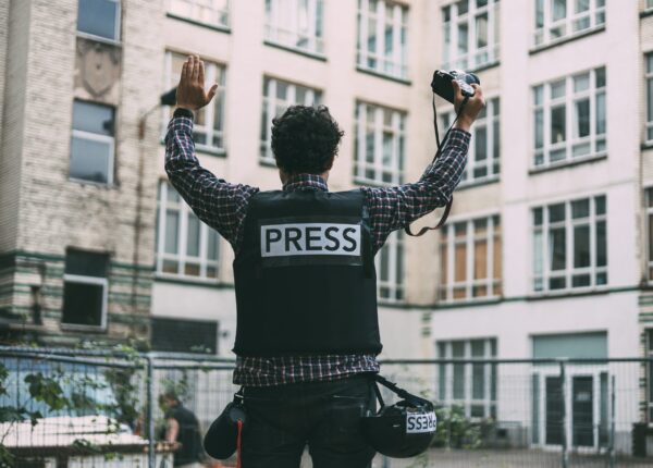 photojournalist-in-bulletproof-vest-holding-his-ca-2025-01-10-05-33-27-utc